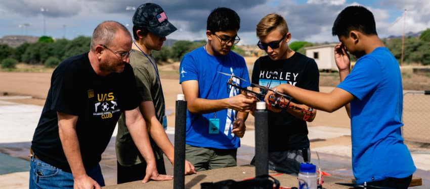 students work on a drone