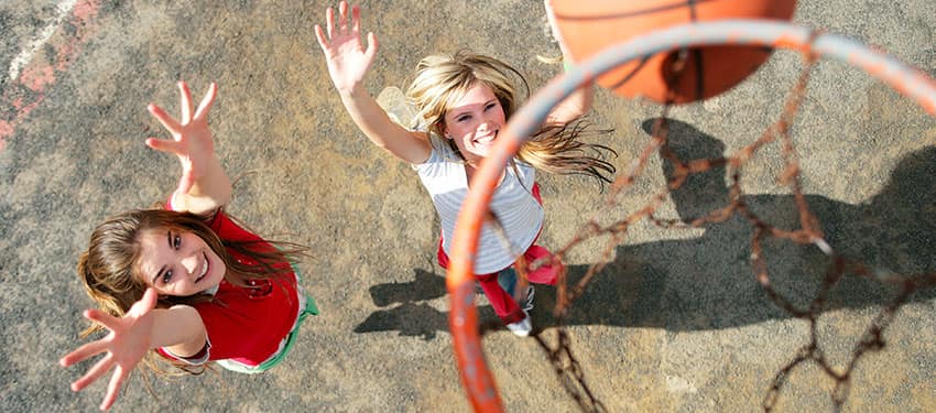 two females play basketball